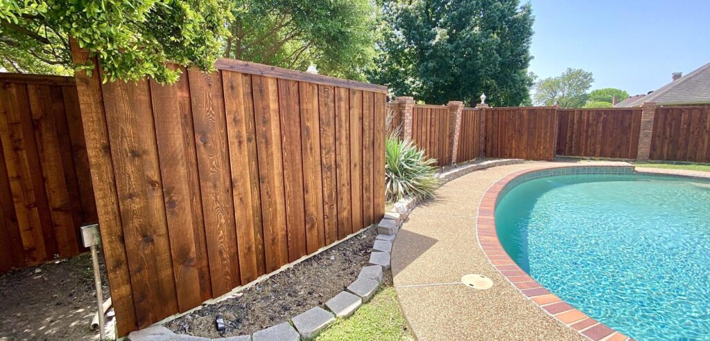 6 ft board on board stained with trim by pool built by fence contractor m&c fence dfw in duncanville texas