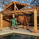 cedar pergola with metal roof by pool