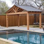 cedar pergola with metal roof by pool