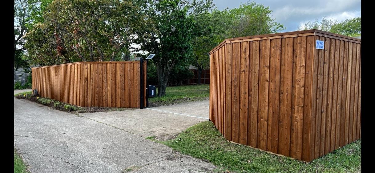 8ft cedar stained board on board privacy fence with cap and trim and a solar-powered automatic driveway gate in Duncanville, TX by M&C Fence DFW
