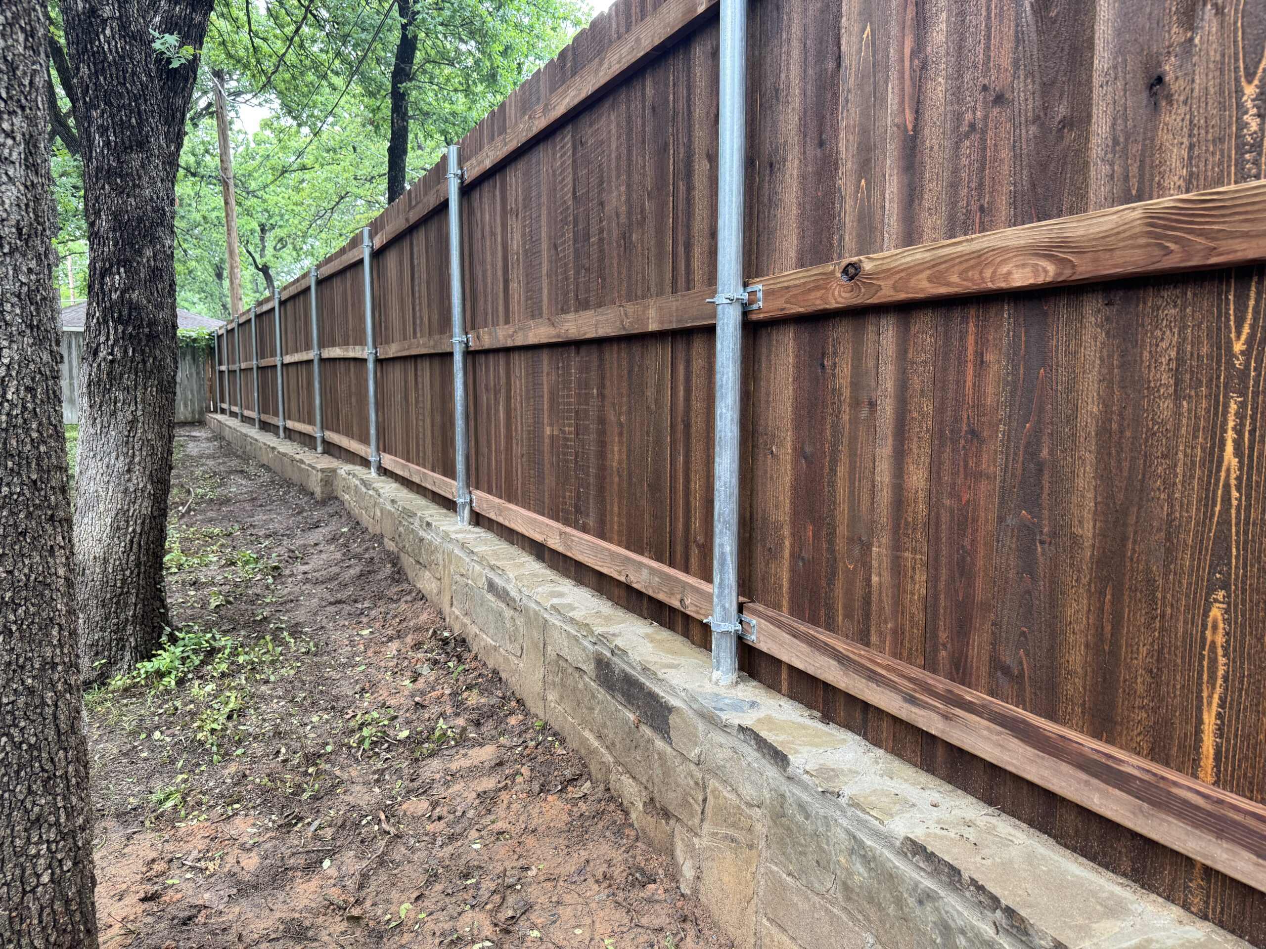 6ft cedar stained privacy fence built on retaining wall in arlington texas by M&C Fence DFW