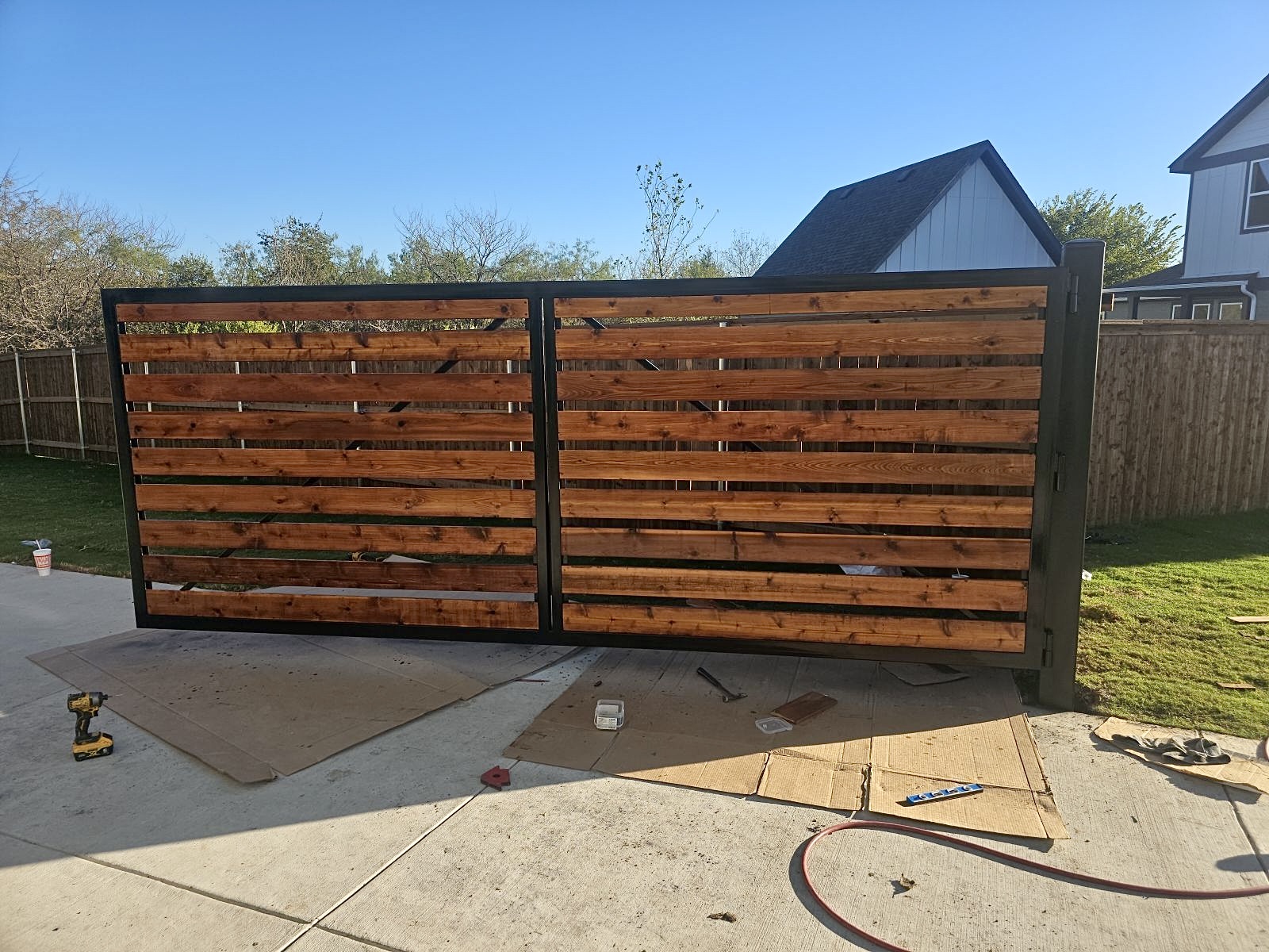 Driveway gate with stained horizontal wood in Mansfield, TX by M&C Fence DFW