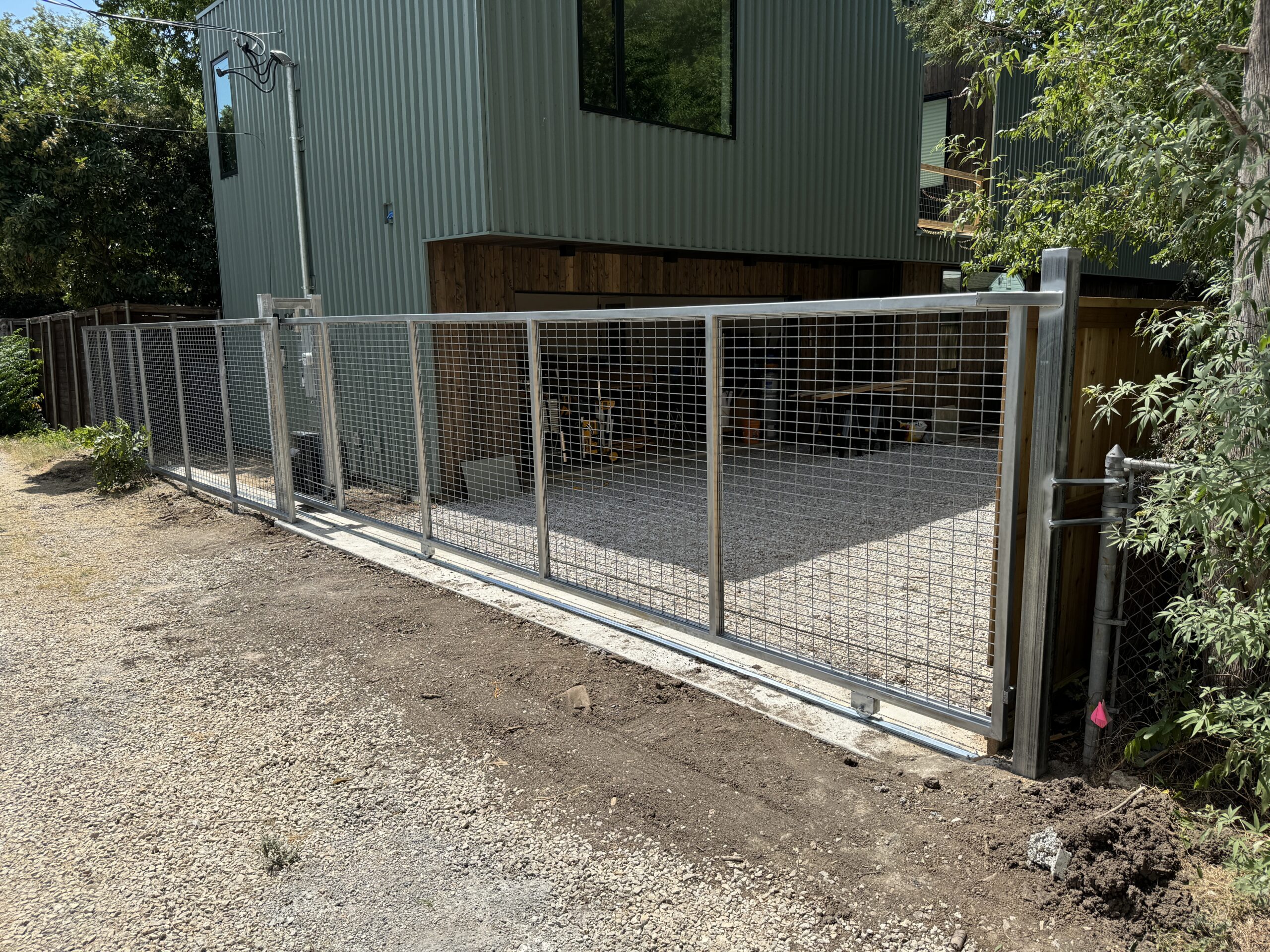 side view of Goat Panel Gate with Operator and Galvanized Steel in Dallas, TX by M&C Fence DFW